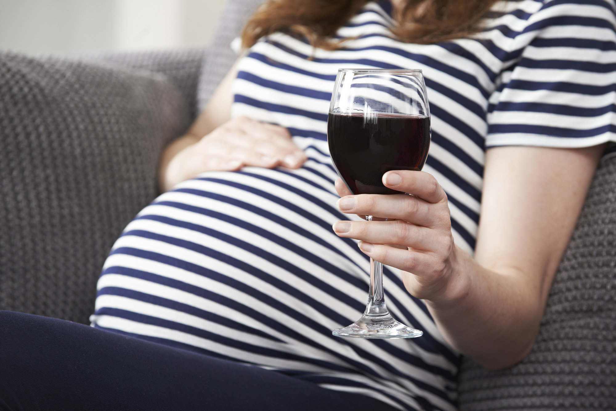 PRegnant woman drinking wine