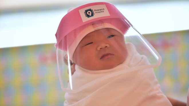 Baby in Thailand wears face shield