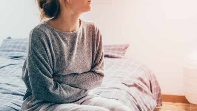 Woman arms crossed sitting on the bed