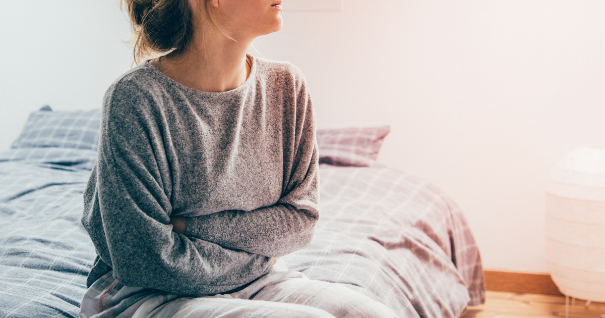 Woman arms crossed sitting on the bed