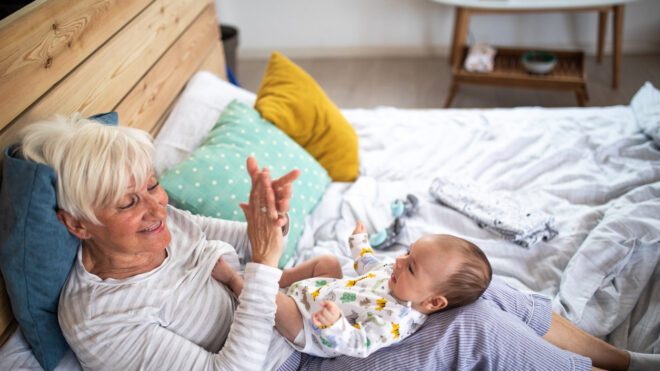 Grandma in bed with grandbaby