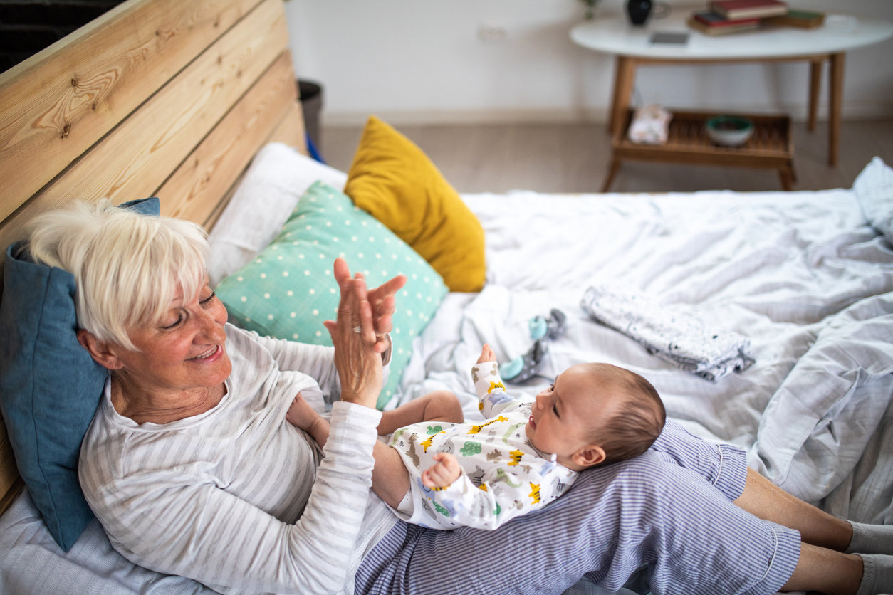 Grandma in bed with grandbaby