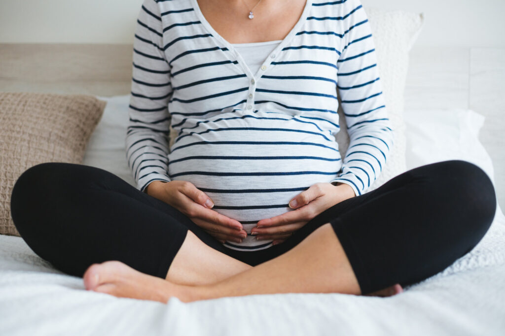 mom cradling baby bump