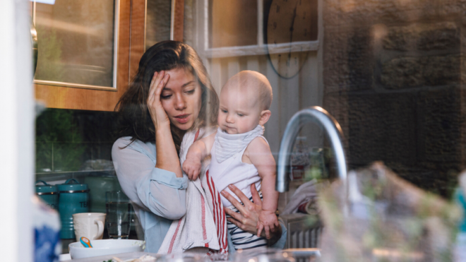 mom frazzled making dinner holding her baby
