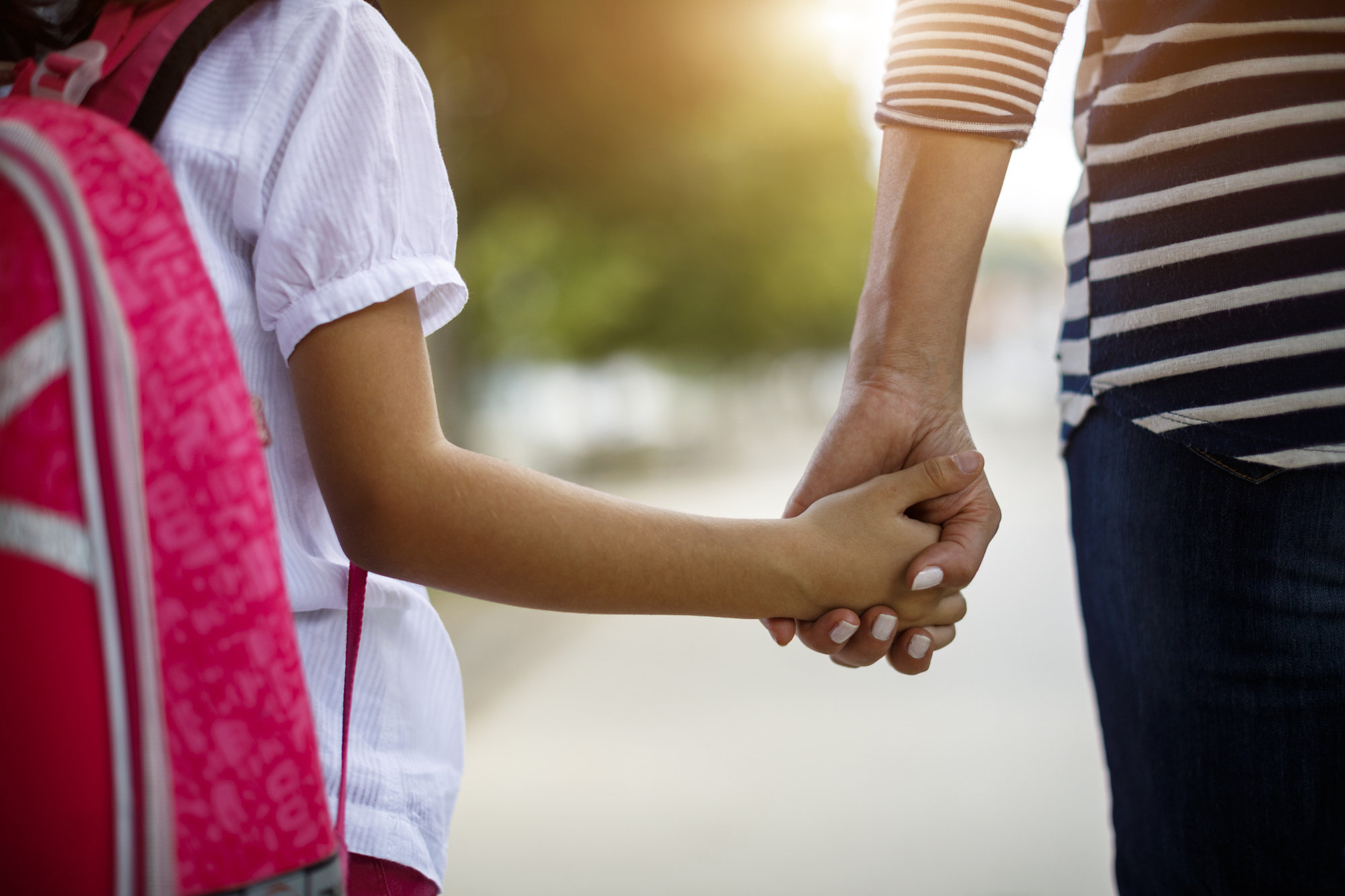 mom and daughter holding hands