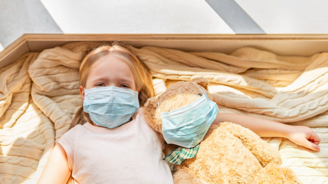 Child wears face mask