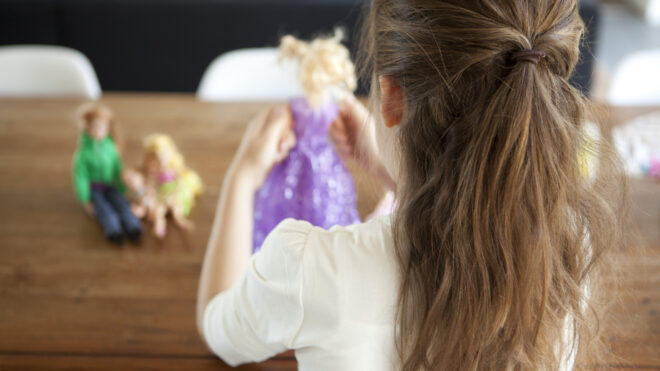 girl playing with dolls