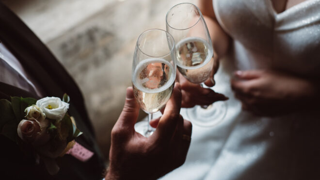 Bride and groom cheers champagne