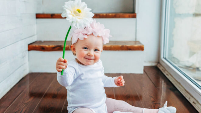 Baby holding flower
