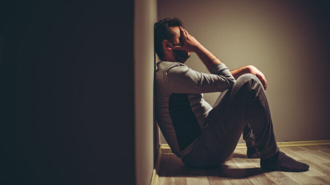 Man crying sitting on the floor