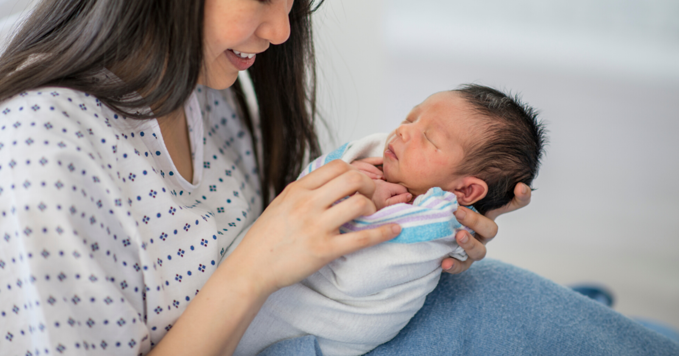 mom holding a newborn baby at the hospital