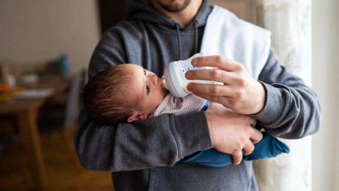 Dad bottle-feeding baby
