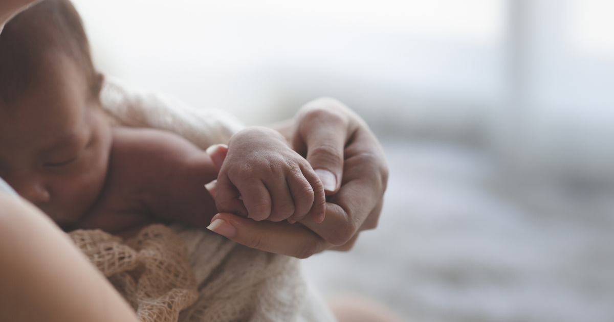 mom holding baby