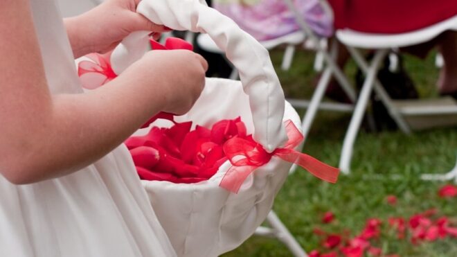 flower girl with red petals in a white basket