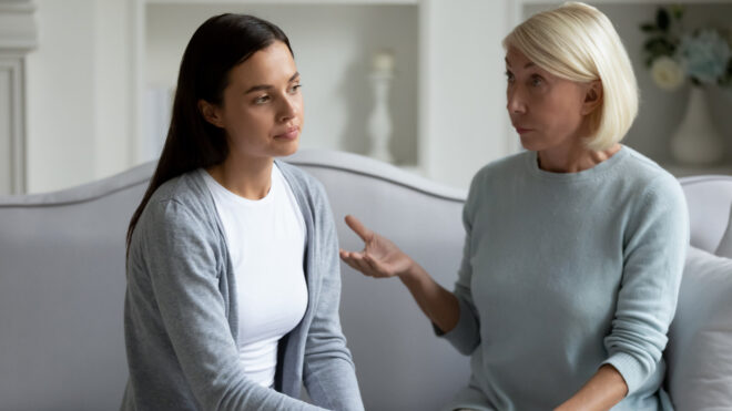 older woman lecturing younger woman