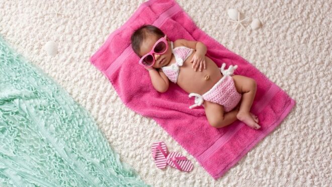 baby laying in the sun at the beach
