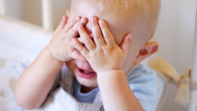 boy covering his eyes