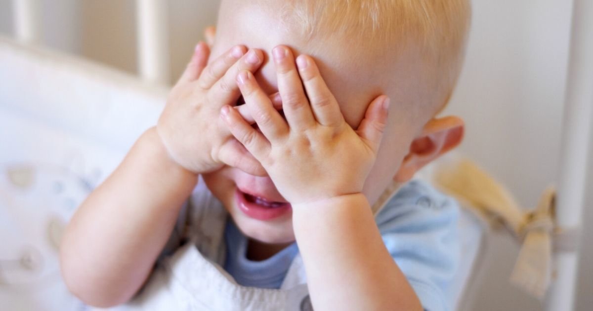 boy covering his eyes