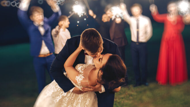 Bride and groom kissing wedding night