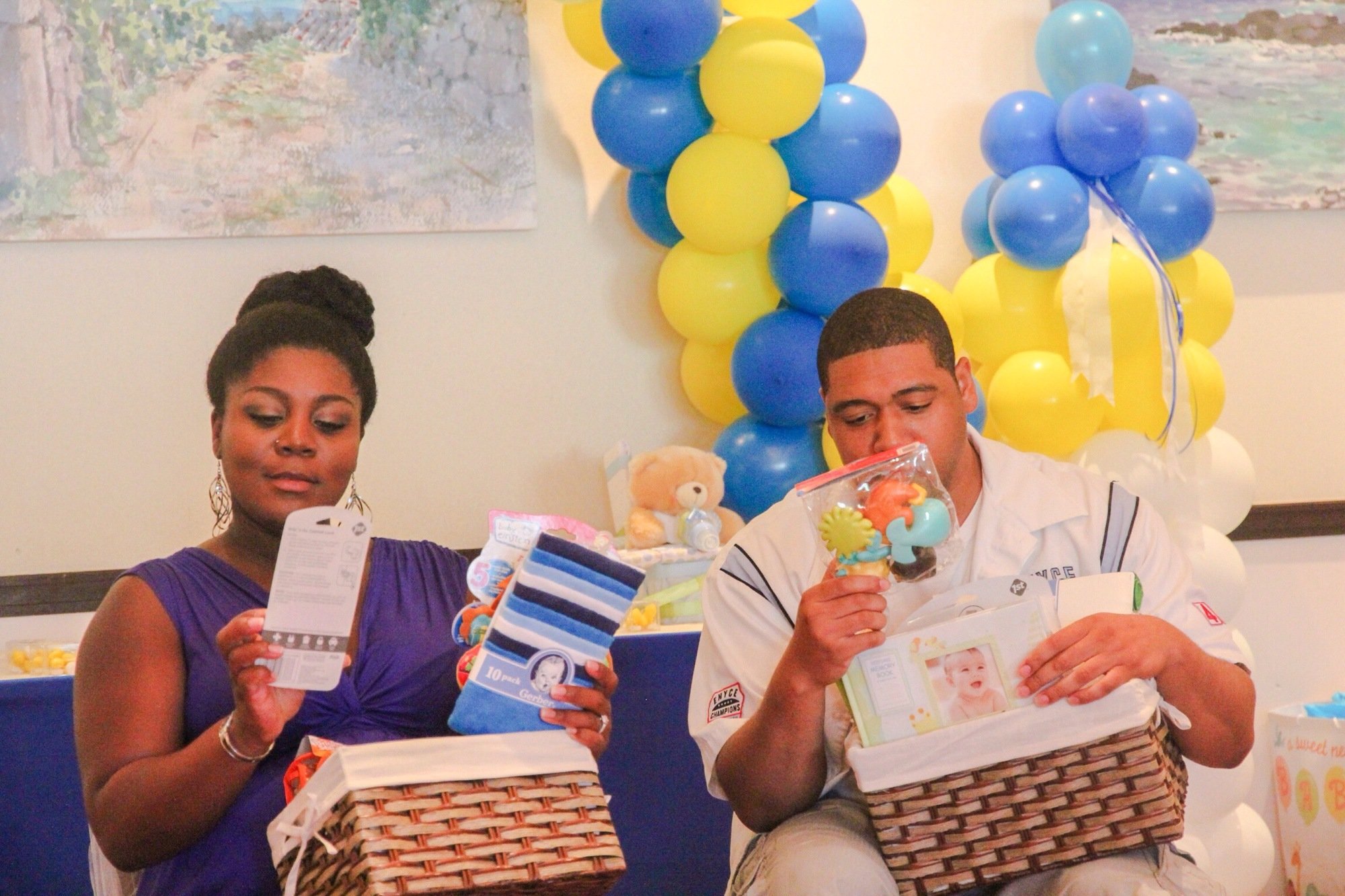 Parents opening gifts at baby shower