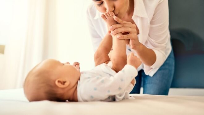 mom kissing baby feet