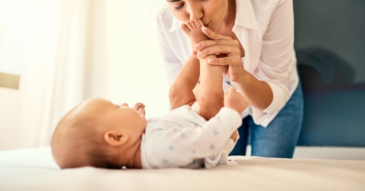 mom kissing baby feet