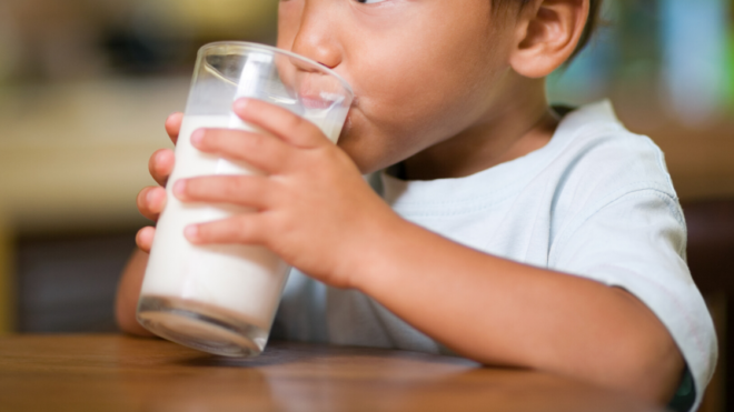 boy drinking a glass of milk