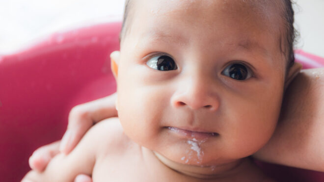 baby with spit up on mouth