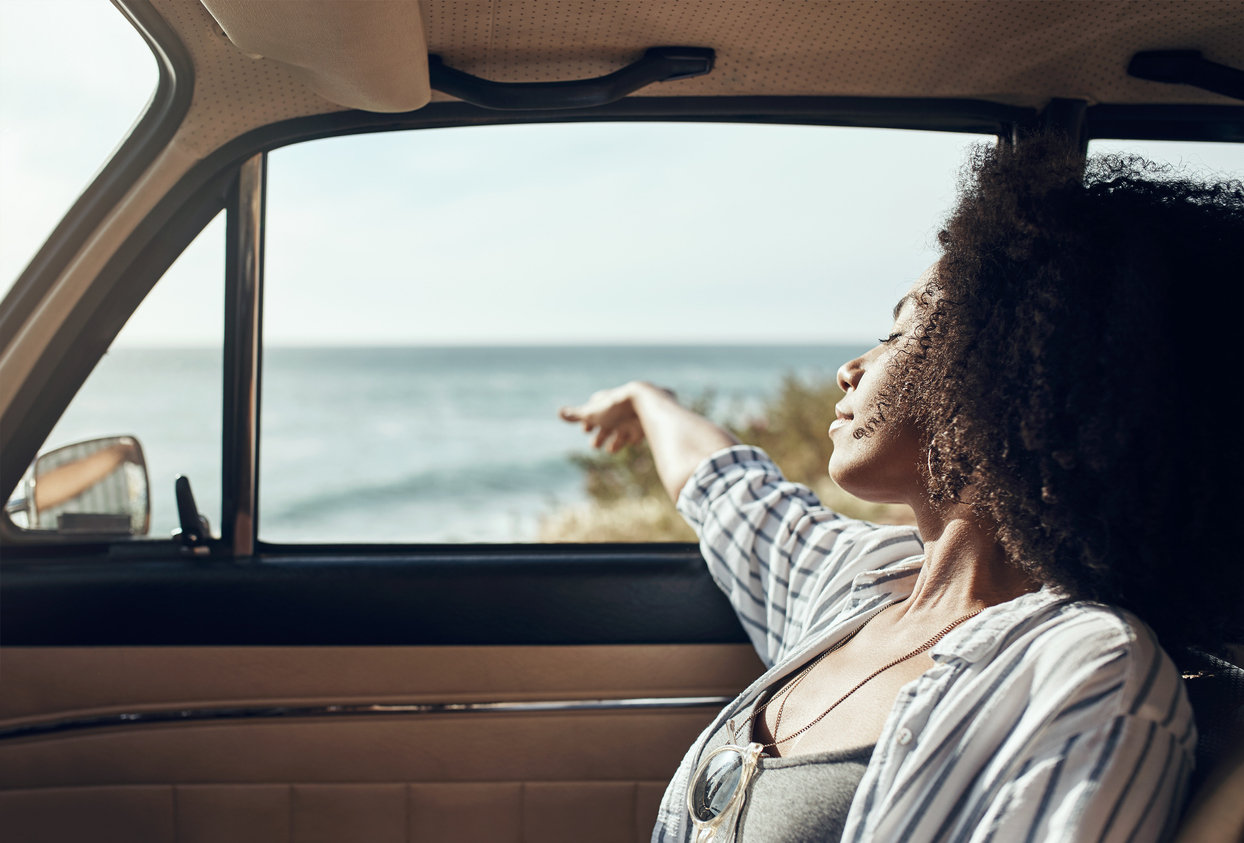 woman asleep in car during road trip