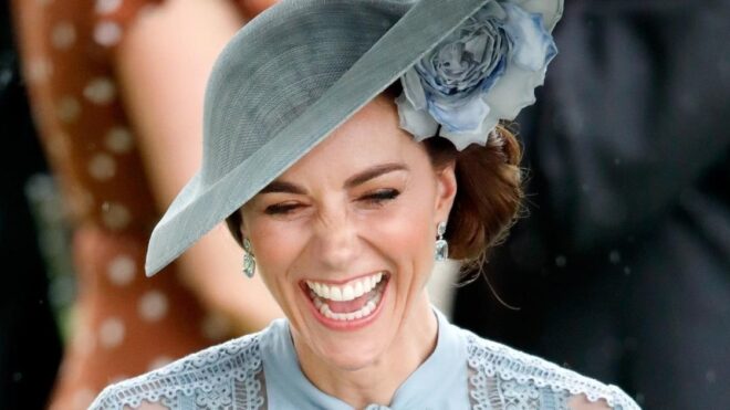 photo of Kate Middleton smiling while wearing a light blue hat