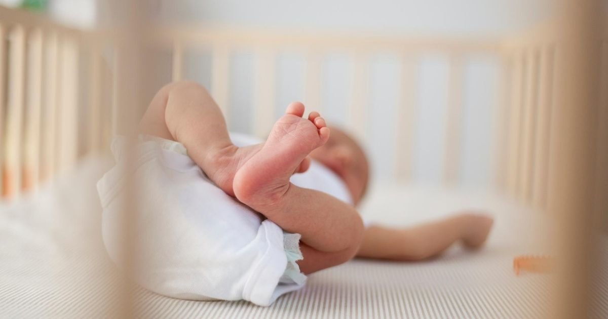 newborn baby sleeping in a crib