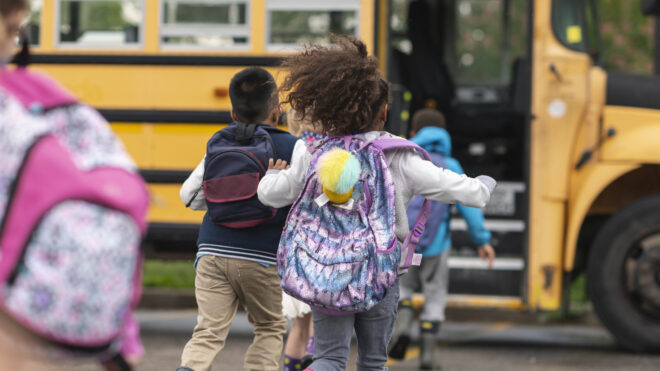 Kids running to school bus