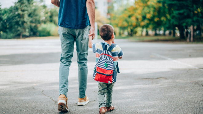 boy going with dad to school