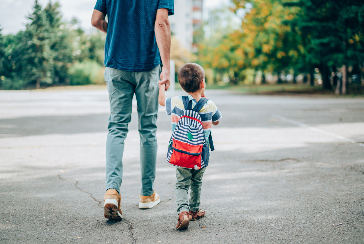 boy going with dad to school