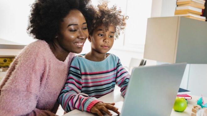mom and daughter looking at computer