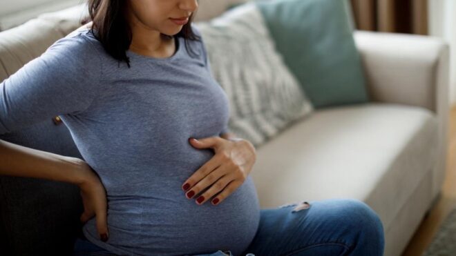 pregnant woman holding belly