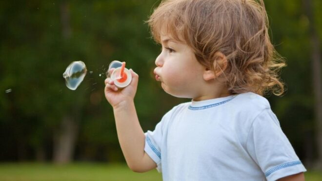 Toddler blowing bubbles