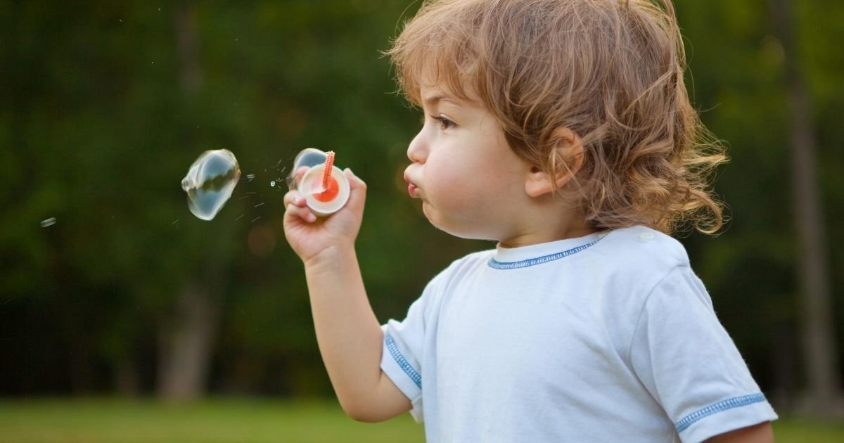 Toddler blowing bubbles