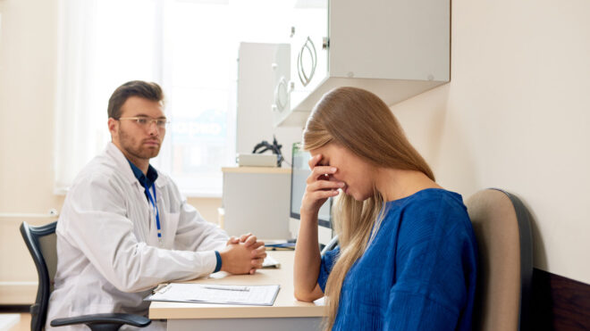 Woman crying at doctor's office