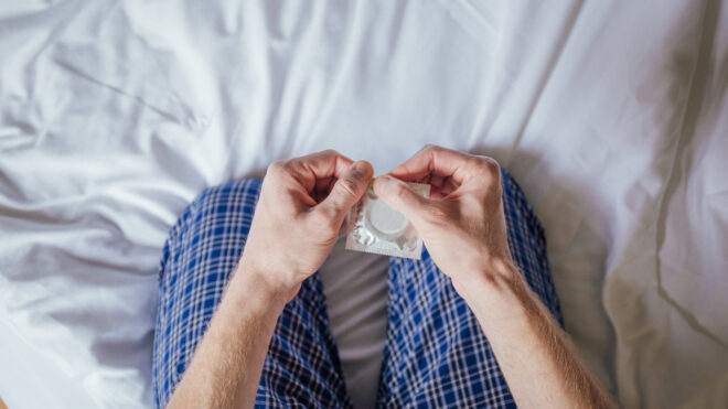 Man holding condom