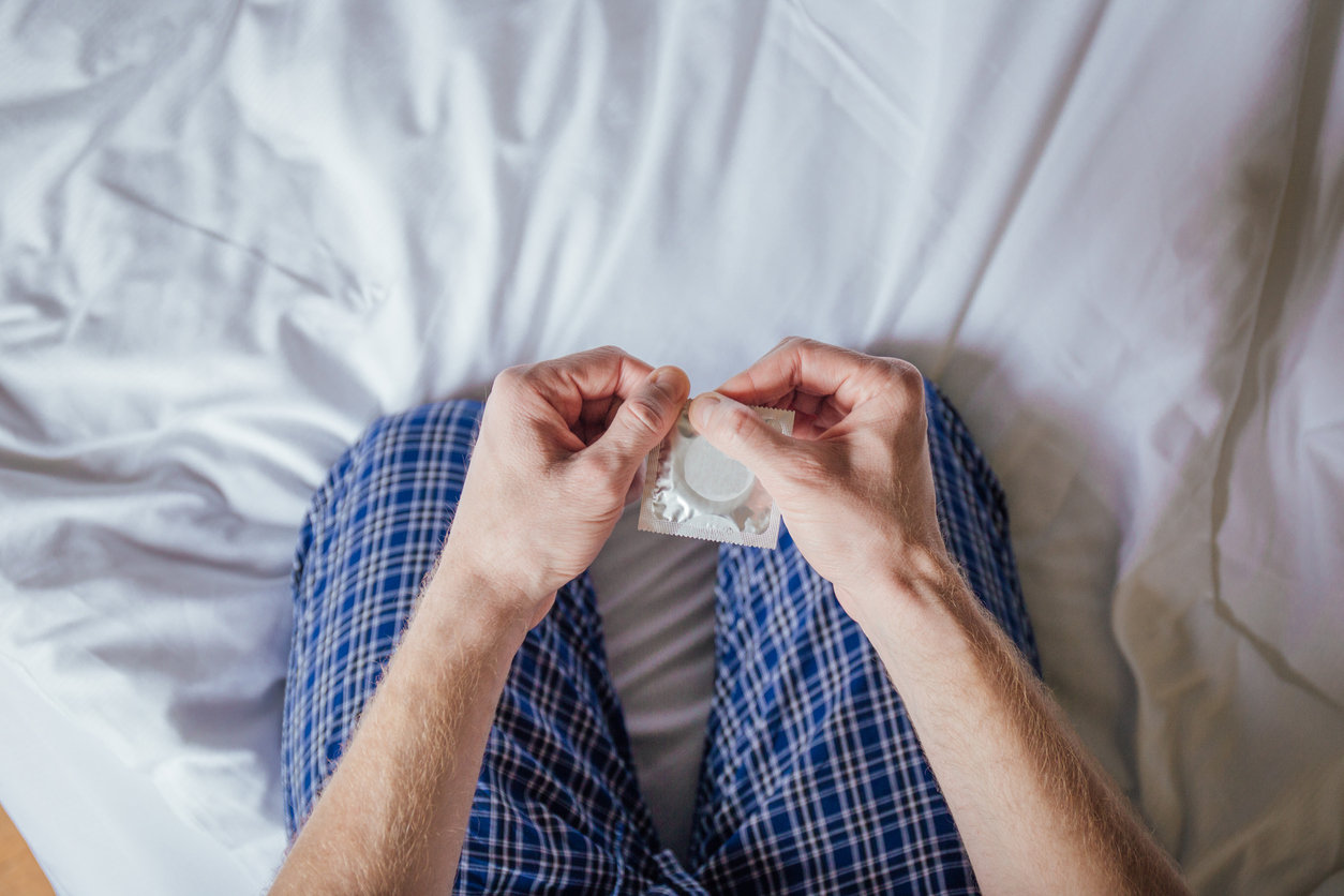 Man holding condom