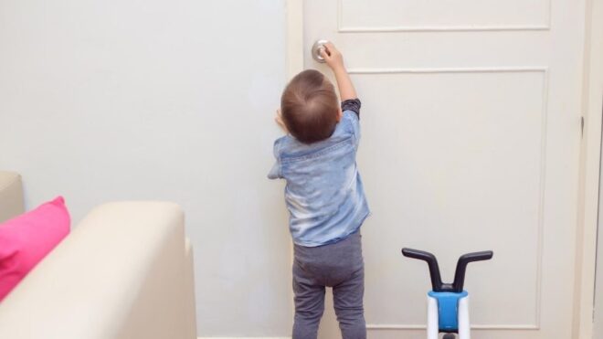toddler trying to open the door