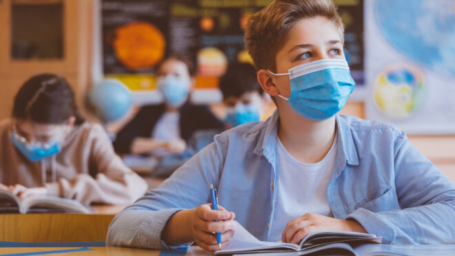Boy wears mask in school