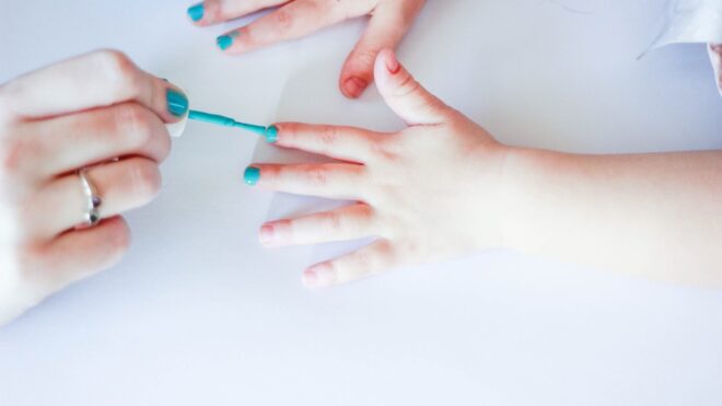 Little kid getting nails painted