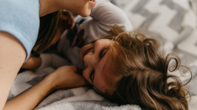 girl and mom cuddling