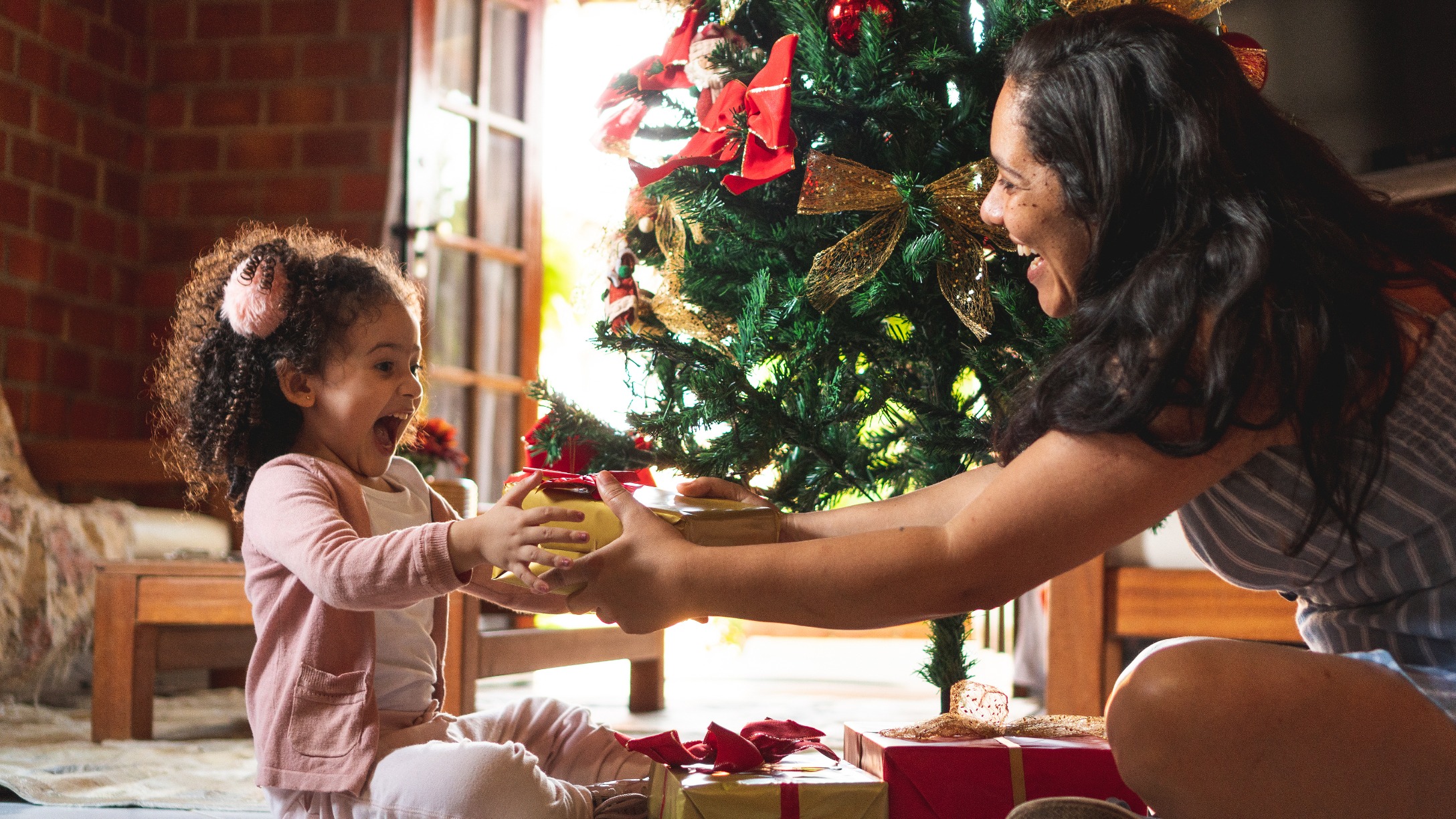 Mother giving child a gift