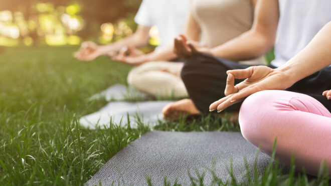 people meditating outside