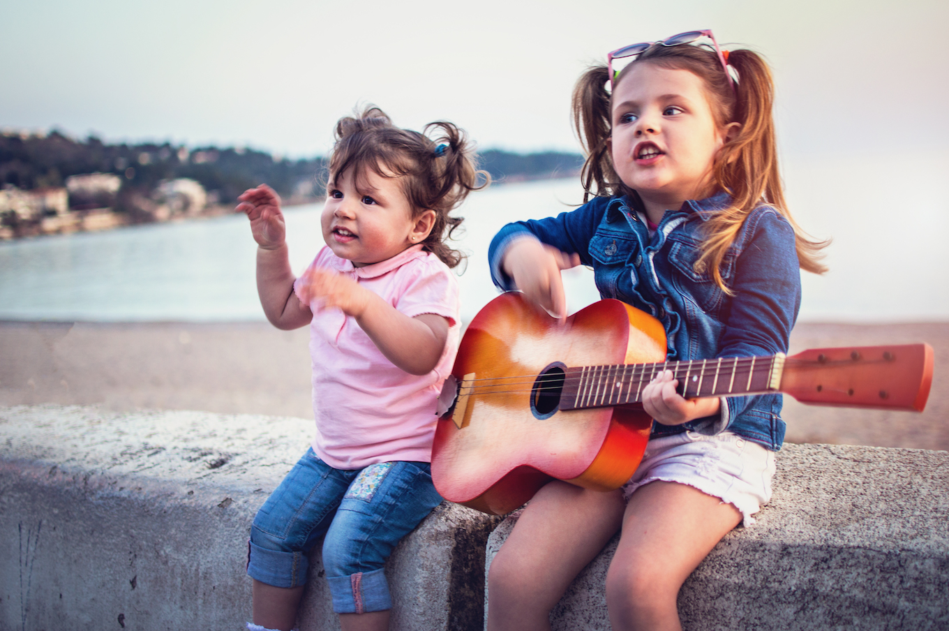 Little children have fun on sunset tropical beach