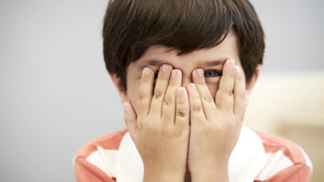 boy covering eyes