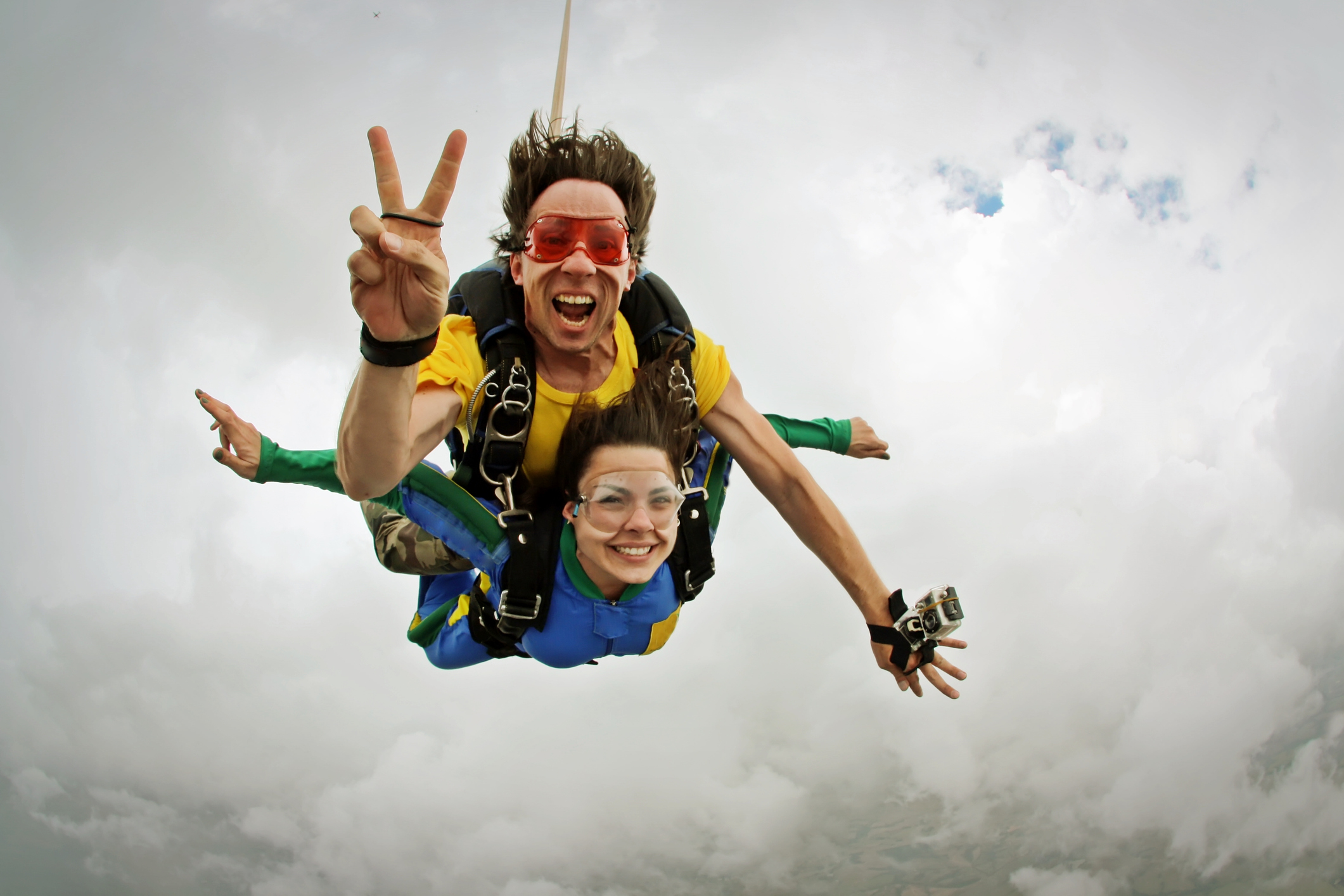 Skydiving tandem happiness on a cloudy day